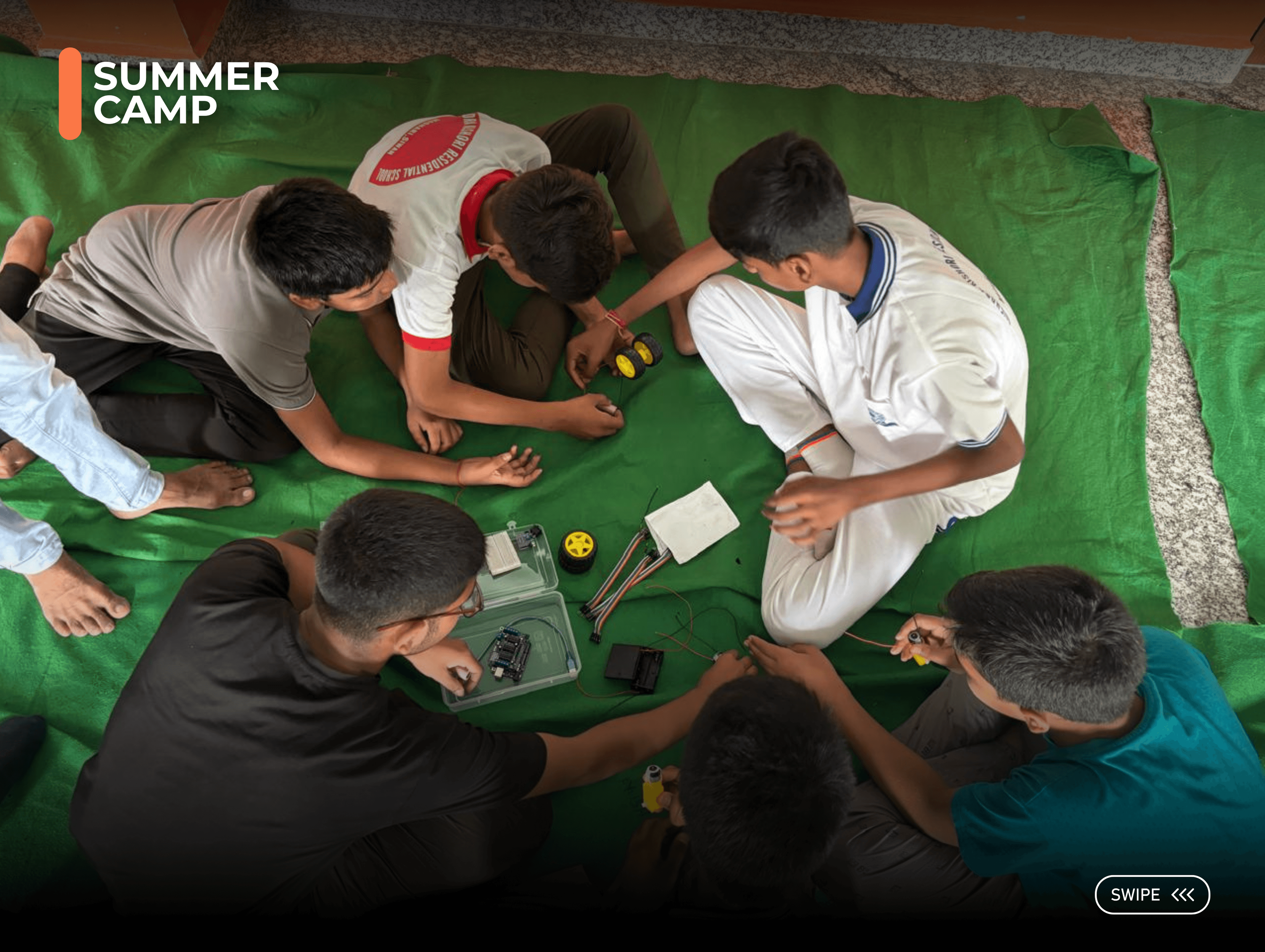 Students assembling robotics kits at summer camp